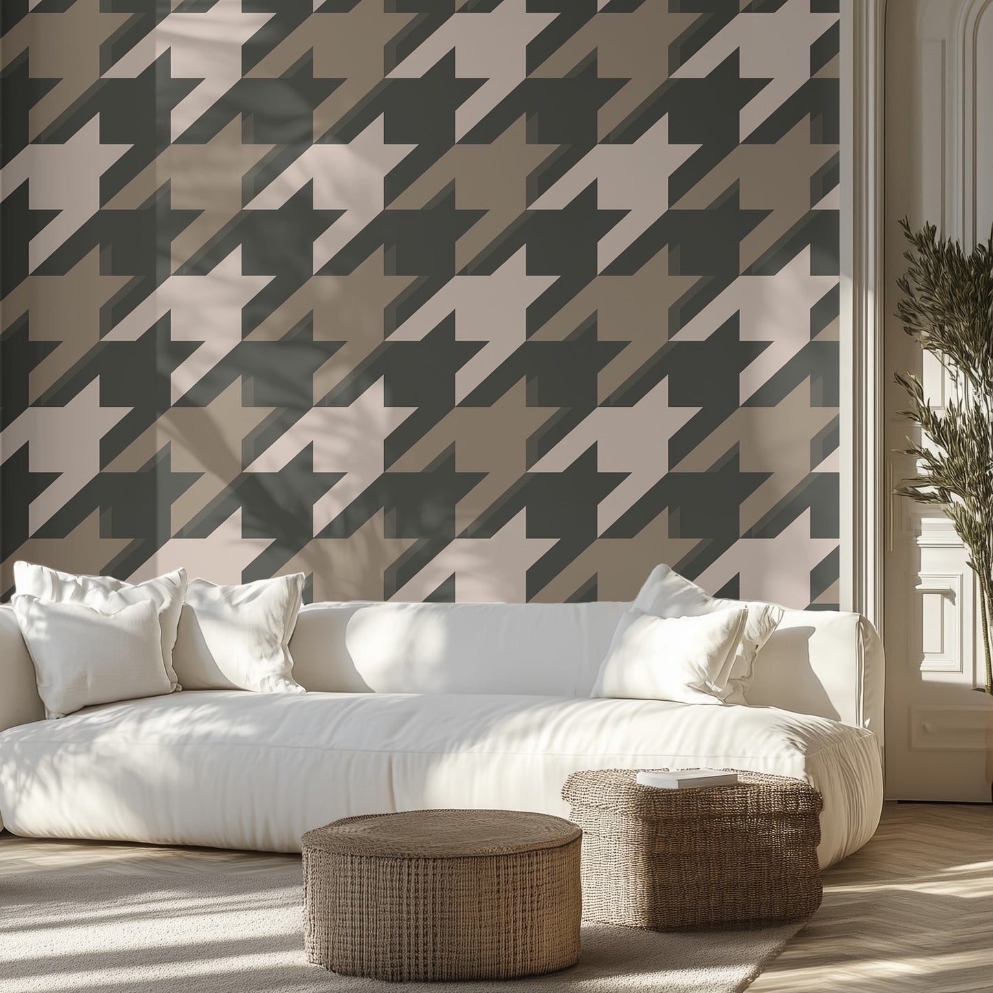 Living room with a white sofa, neutral houndstooth patterned wall, and wicker ottomans.