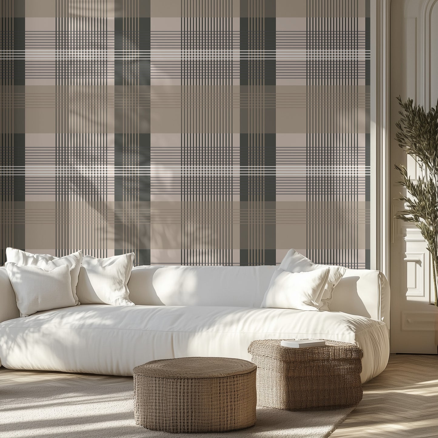 Modern living room with a white sofa, beige and dark taupe plaid wallpaper, and wicker ottomans.