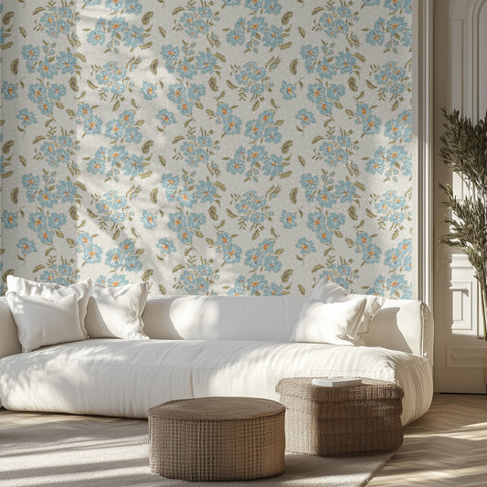 Living room with pale blue floral and polka dot wallpaper, white sofa, and wicker ottomans.