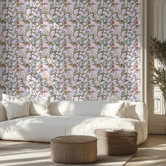 Living room with a white sofa, dove and vine patterned wallpaper, and wicker ottomans.