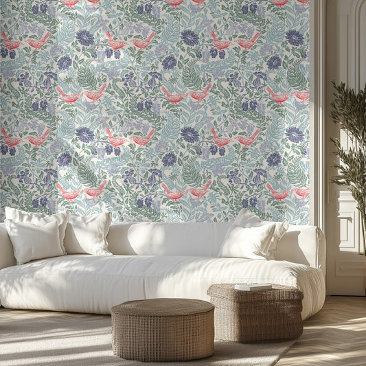 Living room with a white sofa, ornate bird and floral patterned wallpaper, and wicker ottomans.