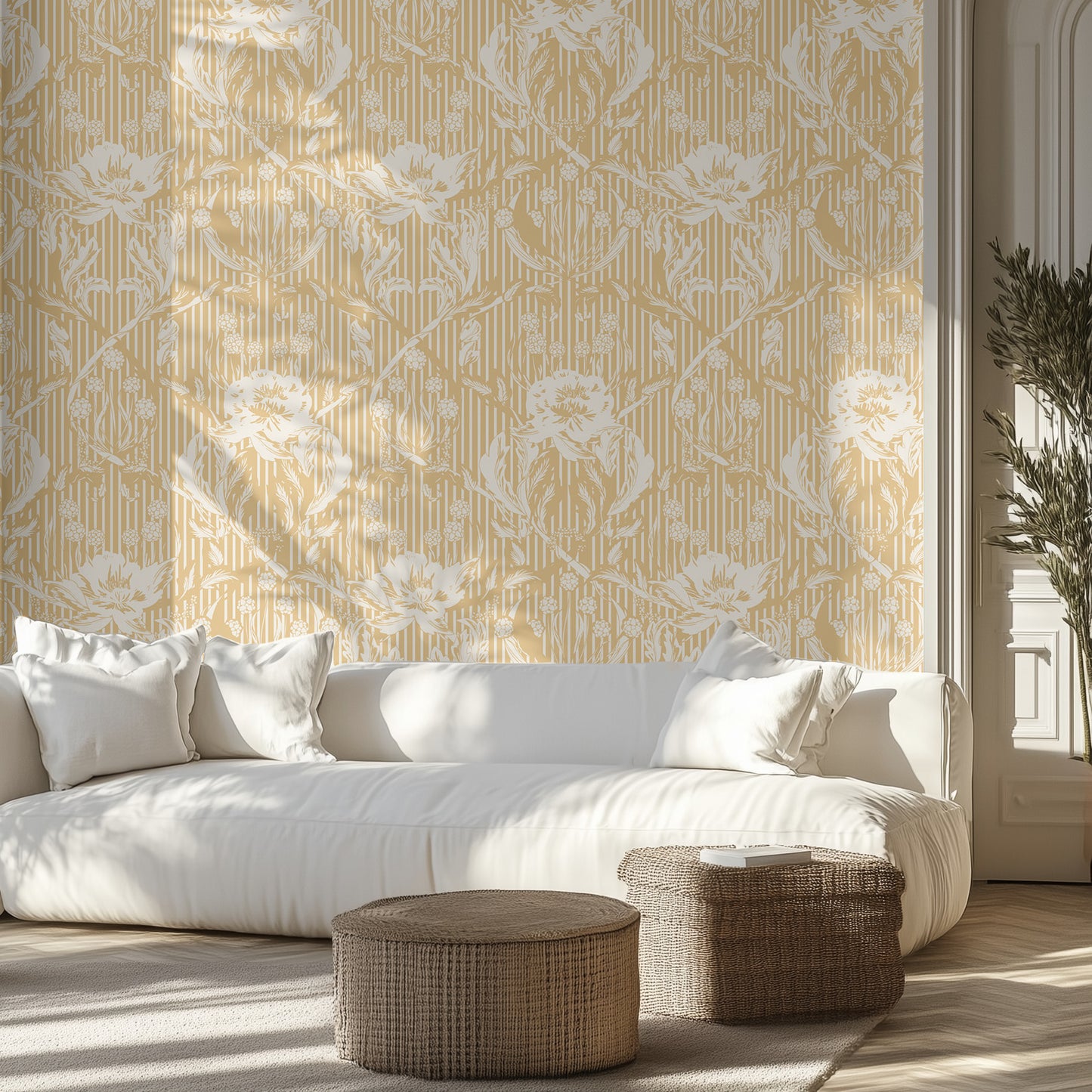 Living room with white sofa, patterned yellow and white floral wallpaper, and wicker ottomans.