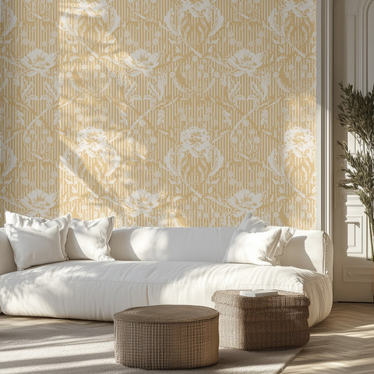 Living room with white sofa, patterned yellow and white floral wallpaper, and wicker ottomans.