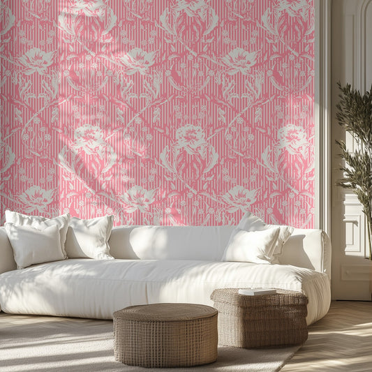 Living room with pink and white floral wallpaper, white sofa, and wicker ottomans.
