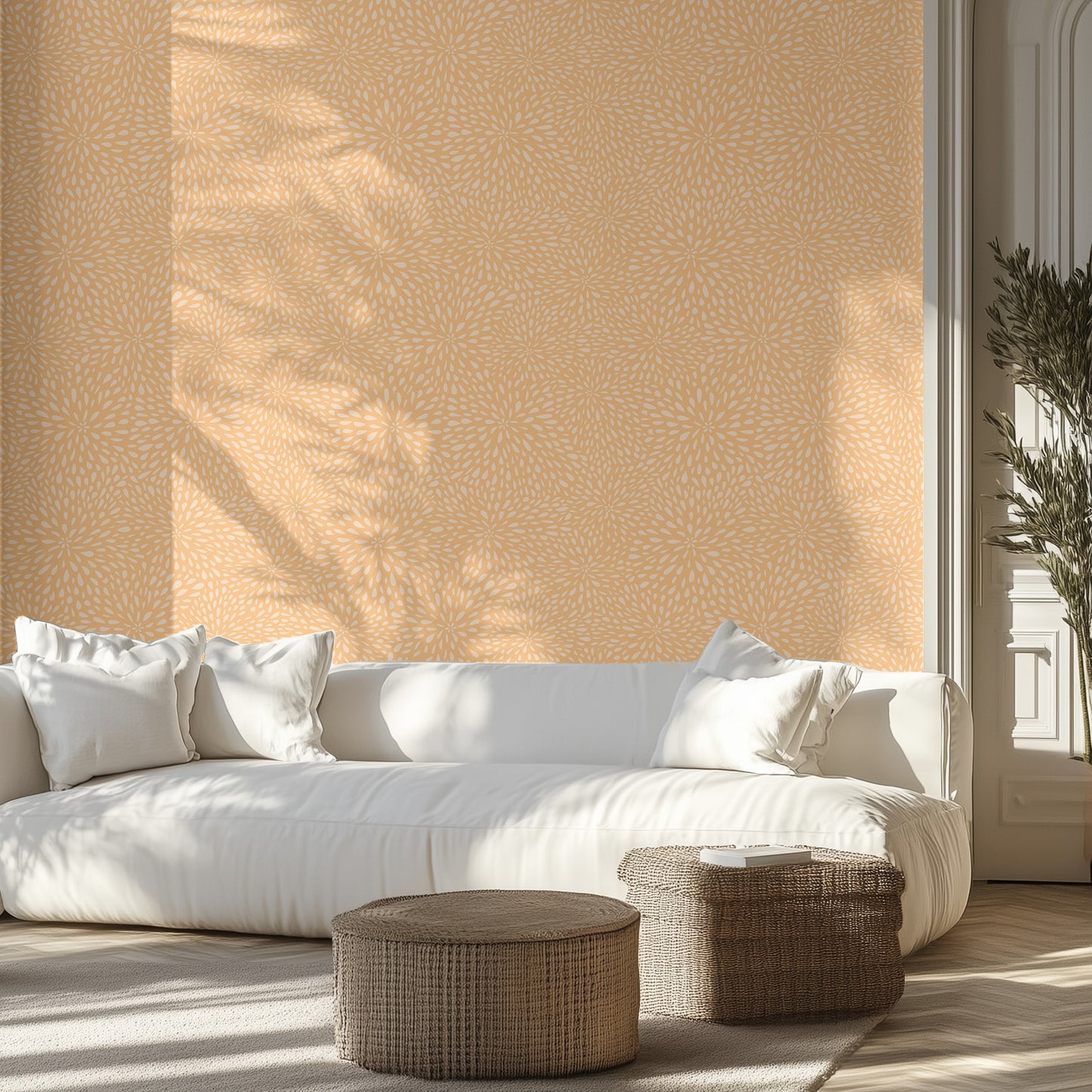 Modern living room with a white sofa, orange textured wallpaper, and wicker ottomans.