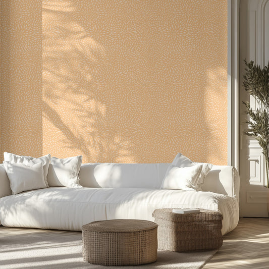 Modern living room with a white sofa, orange textured wallpaper, and wicker ottomans.