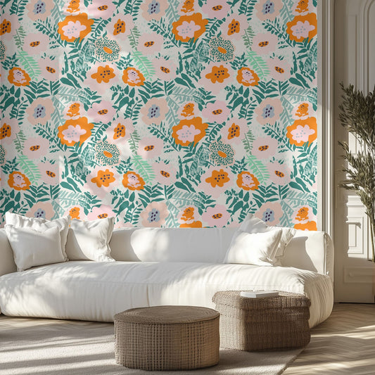 Living room with vibrant, colorful, floral wallpaper, white sofa, and wicker ottomans.