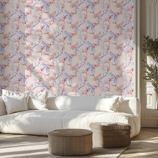 Modern living room with a white sofa, soft pink and blue bird patterned wall, and wicker ottomans.