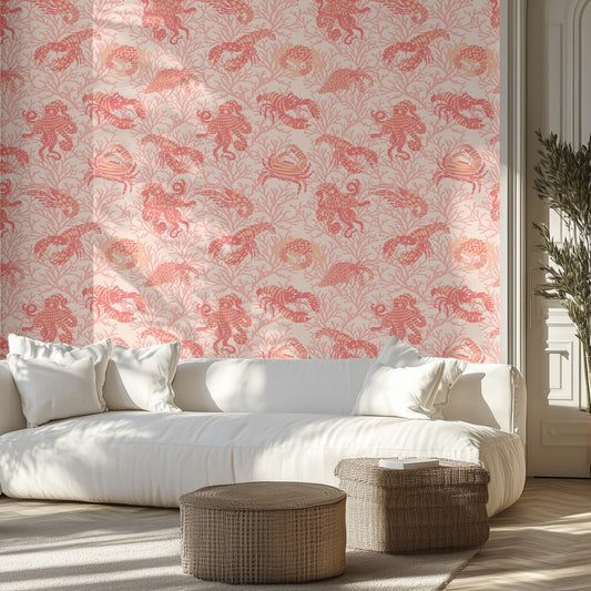 Living room with white sofa, ocean themed patterned coral pink wall, and wicker ottomans.