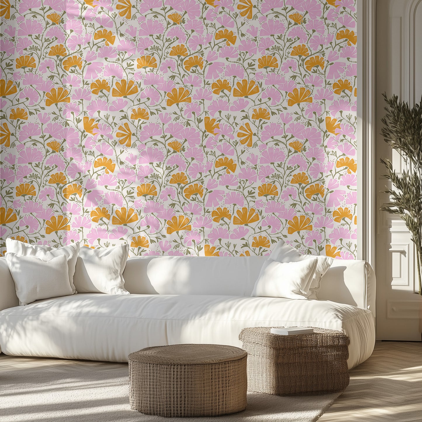 Living room with pink and orange floral wallpaper, white sofa, and wicker ottomans.