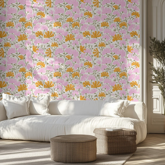 Living room with pink and orange floral wallpaper, white sofa, and wicker ottomans.