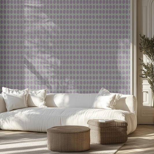 Living room with white sofa, purple polka dot patterned wall, and wooden floor.