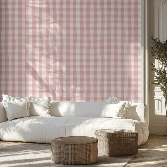 Living room with white sofa, patterned light red and white wall, and wicker ottomans.