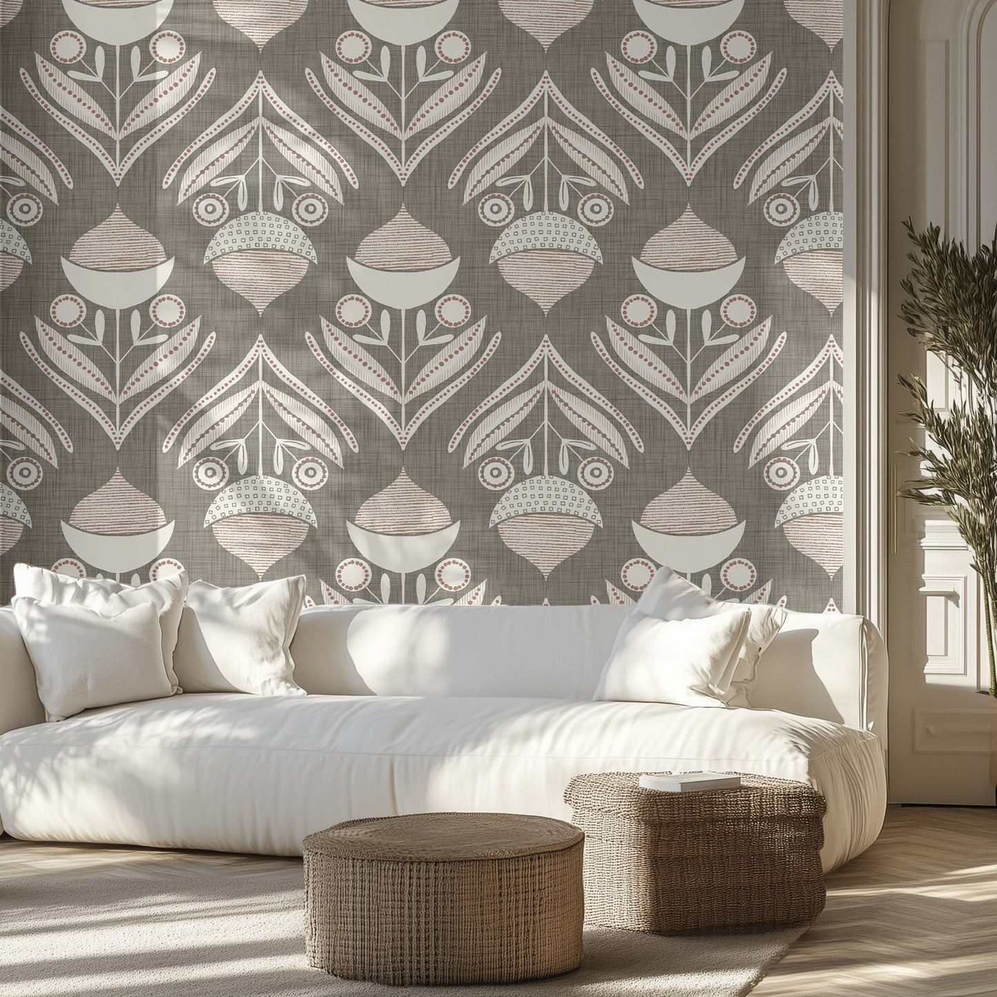 Living room with a muted green and white textured wallpaper pattern of acorns and leaves, white sofa, and wicker ottomans.
