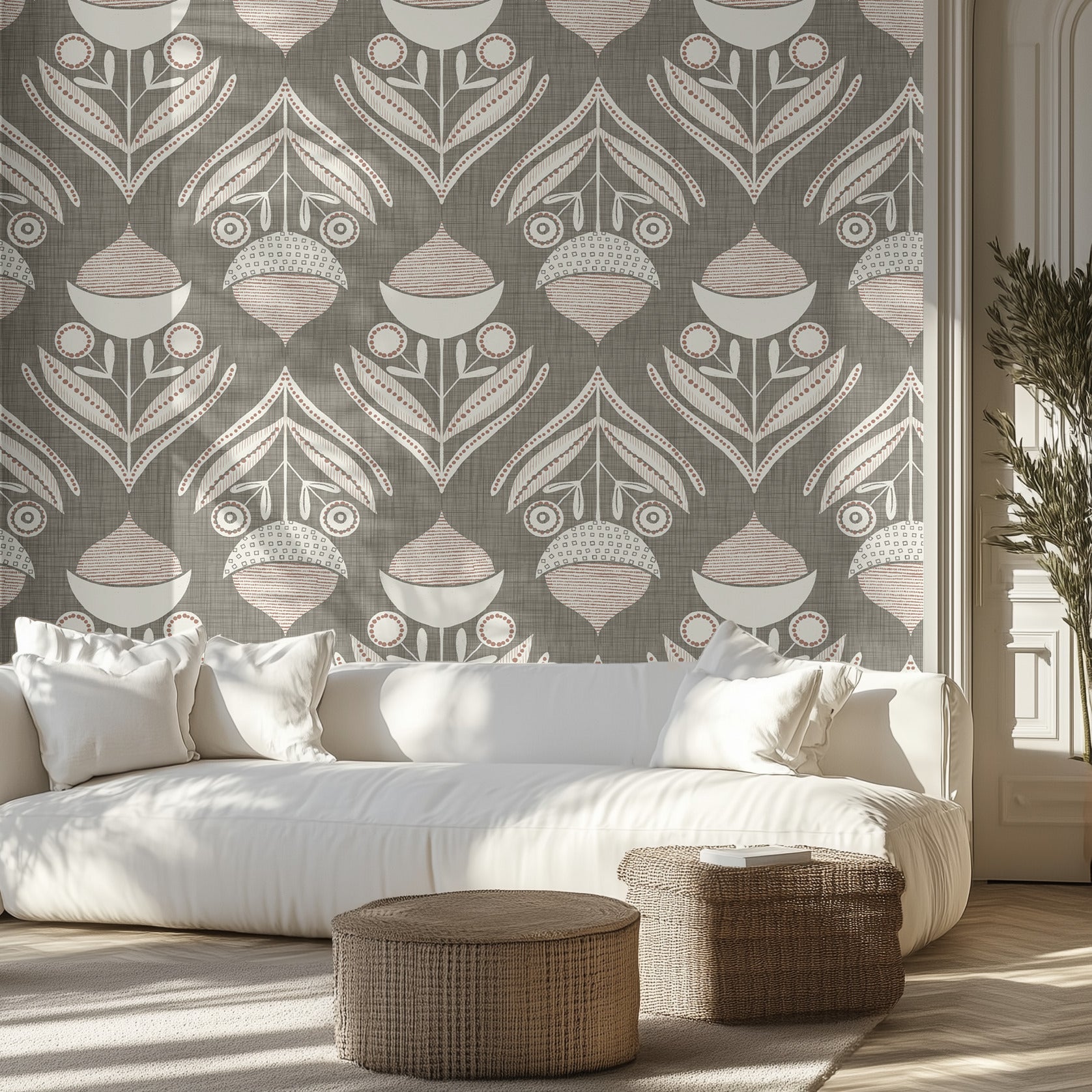 Living room with a muted green and white textured wallpaper pattern of acorns and leaves, white sofa, and wicker ottomans.