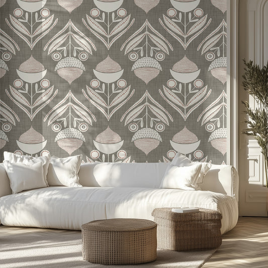 Living room with a muted green and white textured wallpaper pattern of acorns and leaves, white sofa, and wicker ottomans.