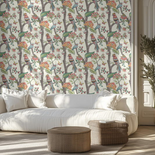 Living room with white floral and bird wallpaper, white sofa, and wicker ottomans.