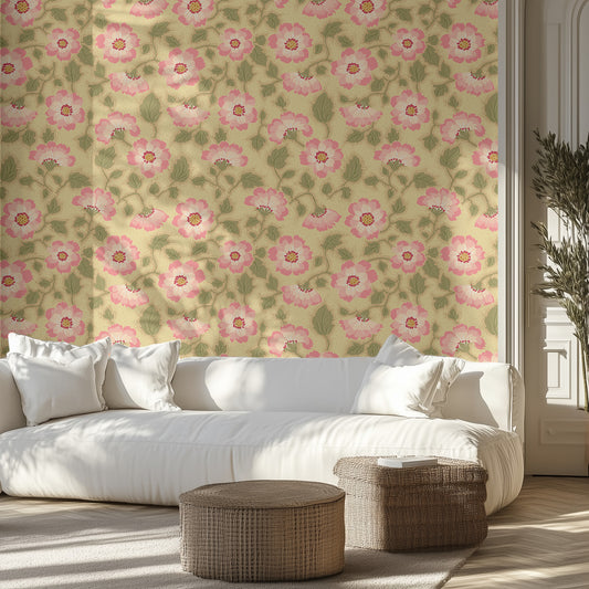 Living room with vintage pink floral wallpaper, white sofa, and wicker ottomans.