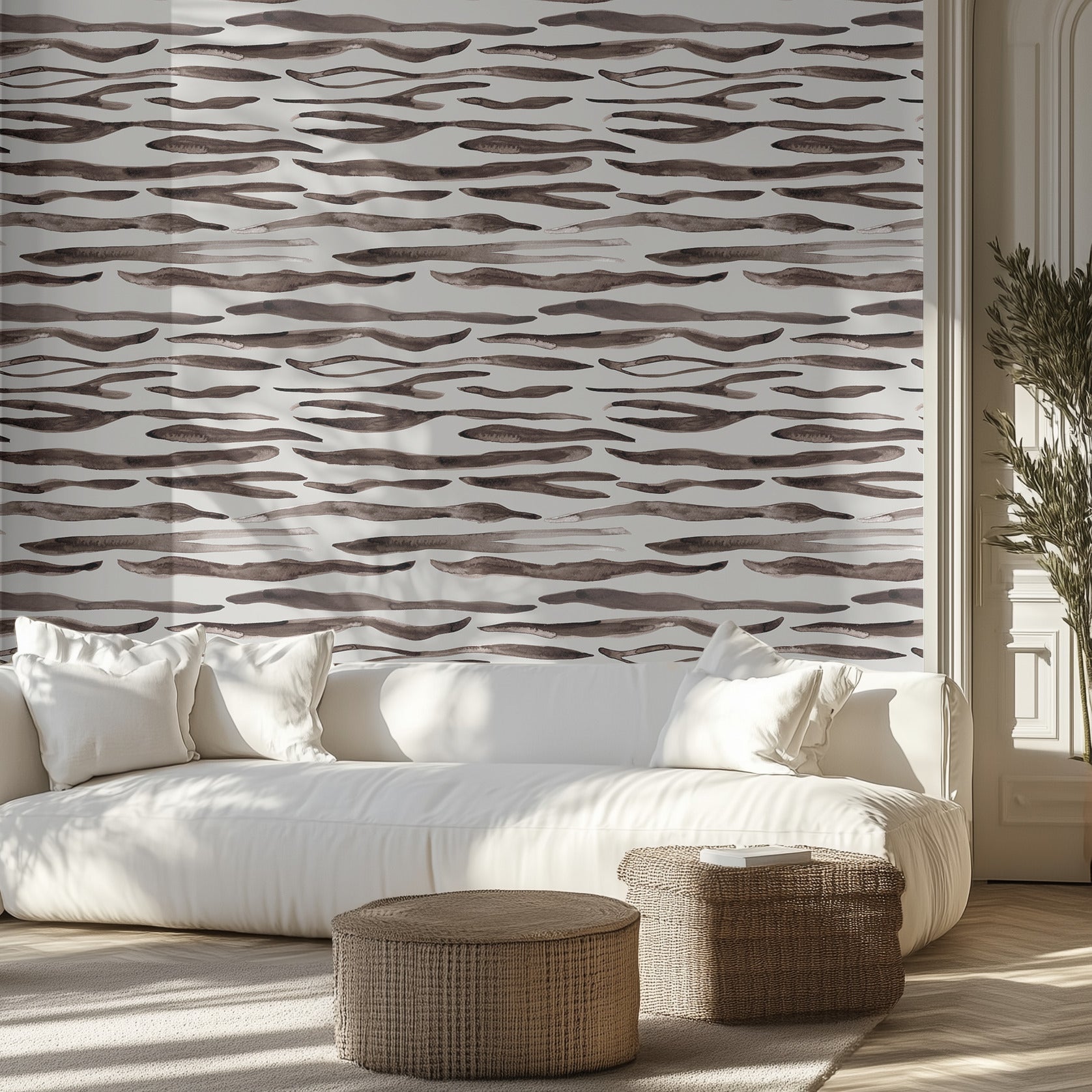Living room with a white sofa, zebra patterned wall, and decorative ottomans.
