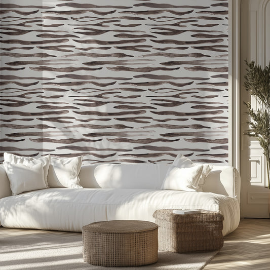 Living room with a white sofa, zebra patterned wall, and decorative ottomans.