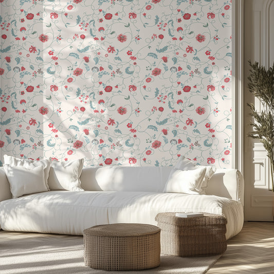 White sofa with decorative pillows in a room with a floral textured wall and wooden floor.