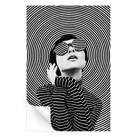A woman in sunglasses poses in front of concentric black and white circles, creating a dynamic and fashionable artwork.