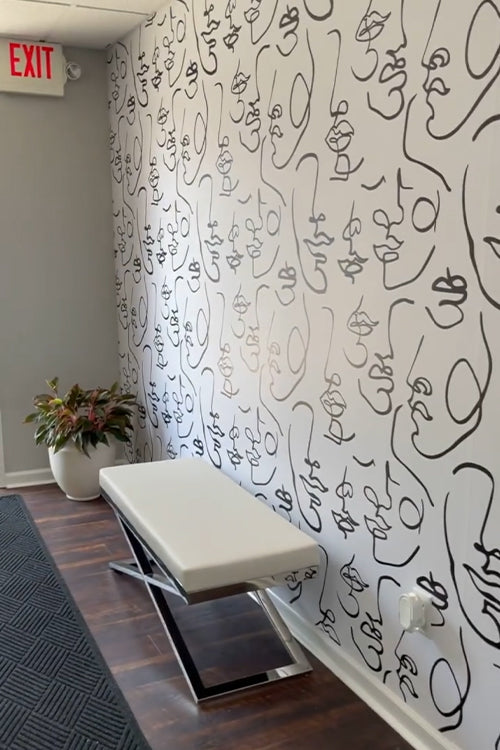 Black and white abstract wallpaper pattern on a wall in an entryway loading=