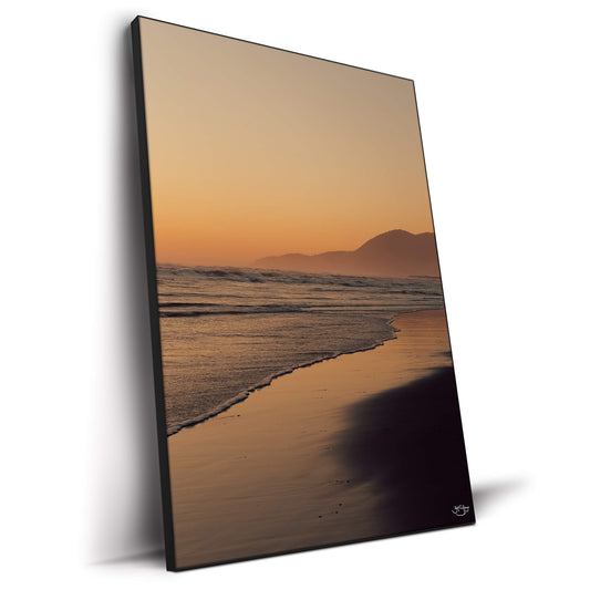 Vibrant sunset over the ocean with soft colors reflecting on the water.