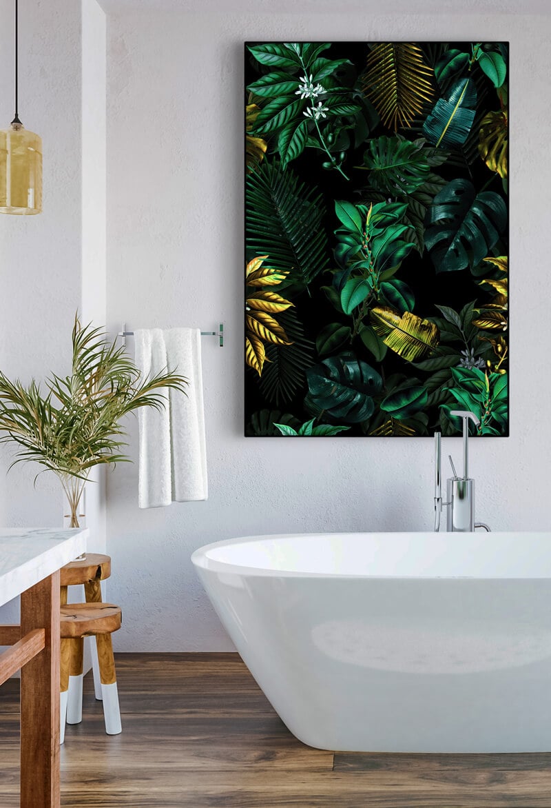 Huge green bathroom wall art featuring tropical plant leaves hangs above white soaking tub.