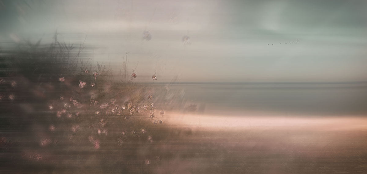Moody dramatic blurred beach scene.