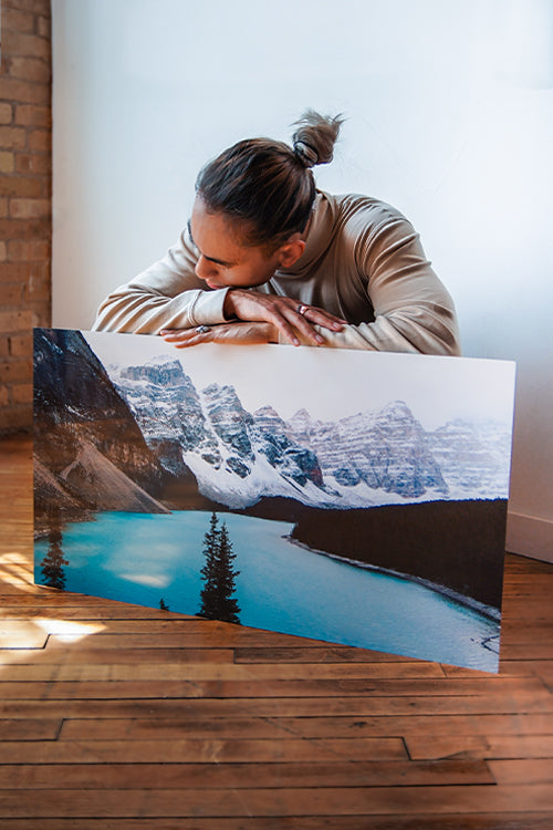 Man looking down at mountain metal print loading=