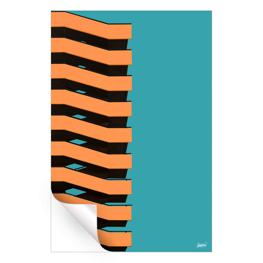 Bright building with bold orange and black zigzag bands against a teal background.