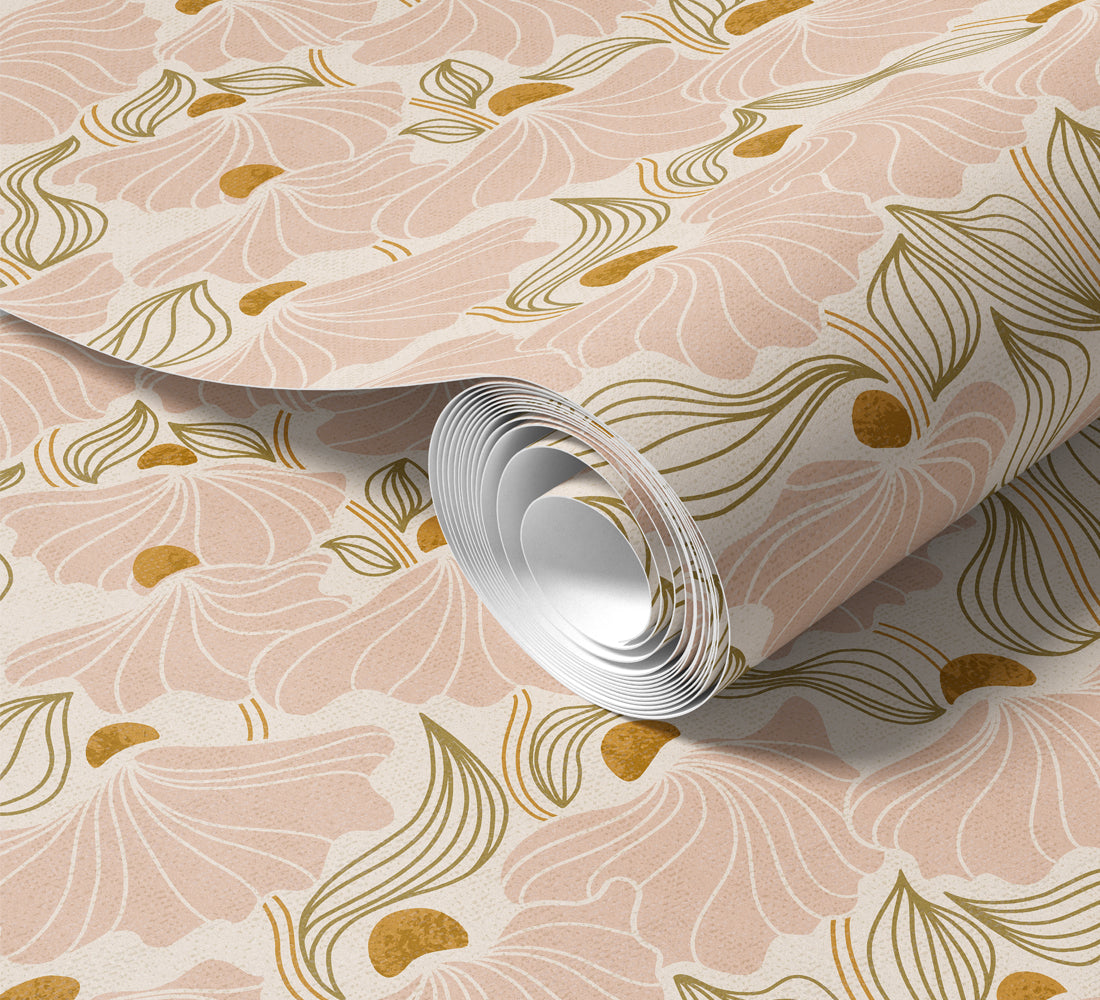 Roll of floral-patterned wallpaper with gold accents on a light pink background