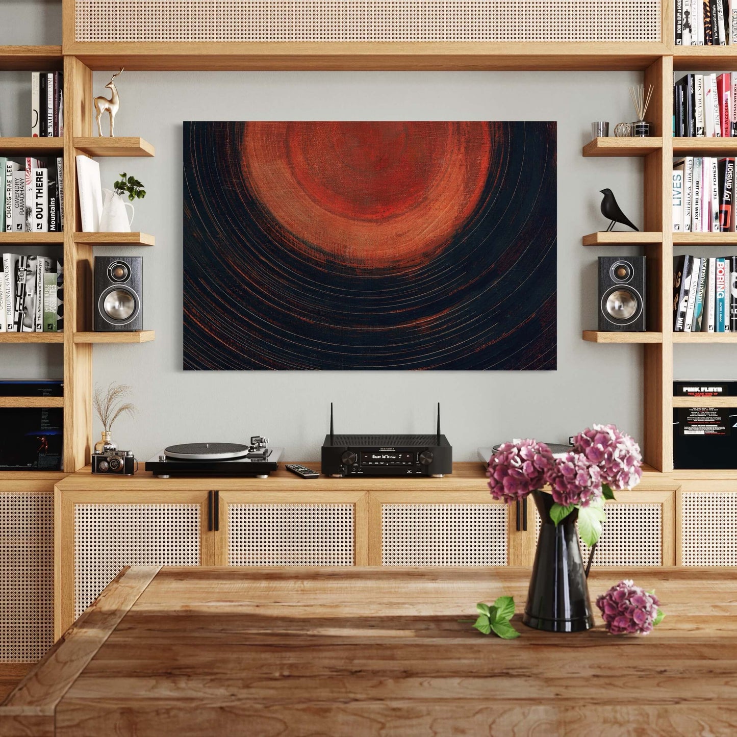Large contemporary oil painting artwork in black and orange hangs horizontally in boho living room entertainment center in place of the TV.