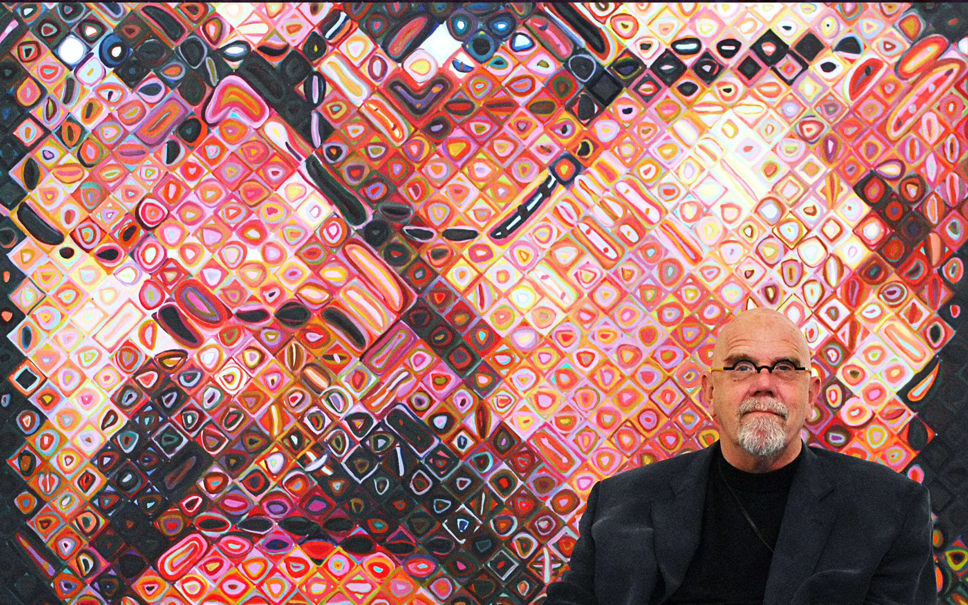 Chuck Close Posing in front of Painted Self-Portrait