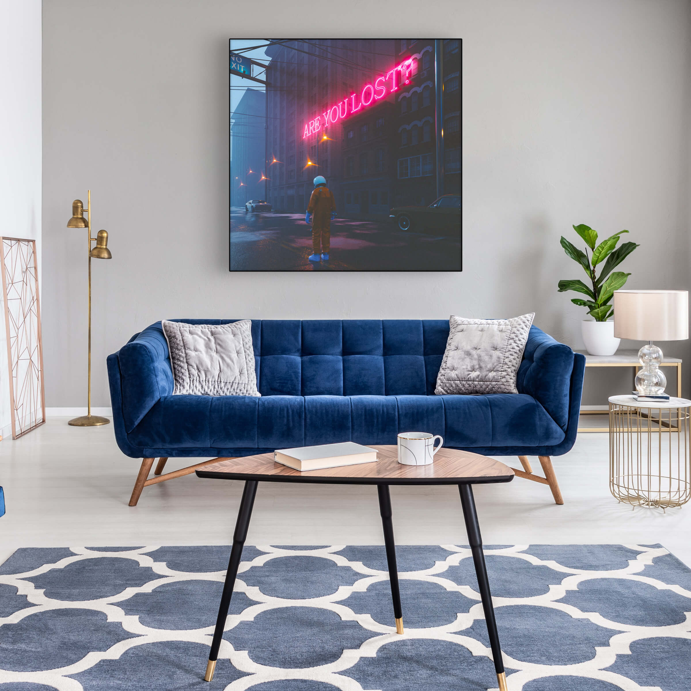 Large square surreal astronaut wall art with pink neon sign that reads "are you lost?" hangs above blue couch in living room