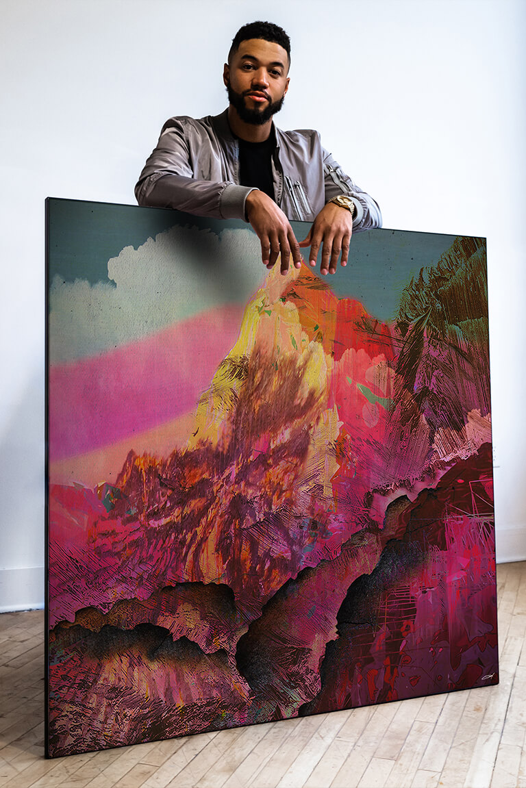 Man leans over extra large square magenta wall art of abstract mountain range.