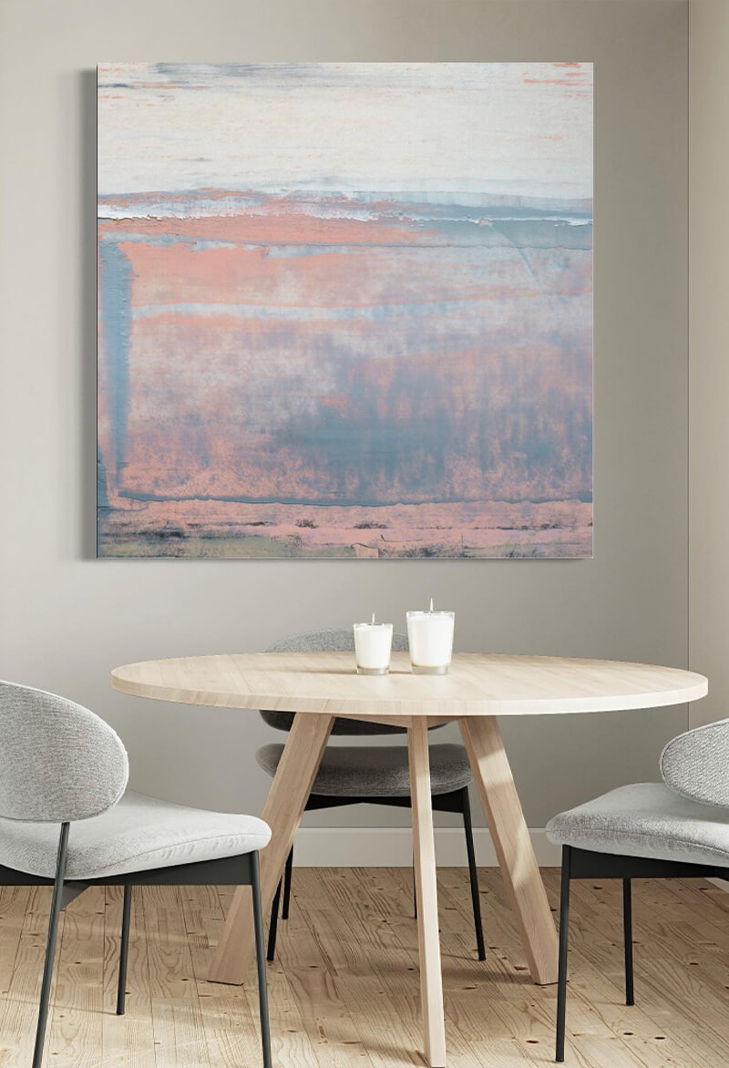 Extra large blue and pink abstract wall art hangs above modern kitchen table.