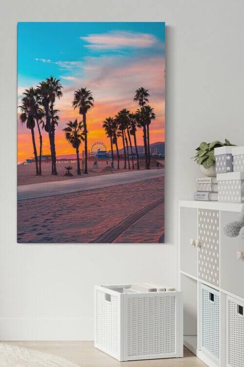 Large sunset photo taken at Santa Monica pier in California hangs in neutral kid's room.
