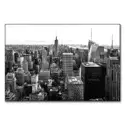 Black and white aerial view of New York City with the Empire State Building prominently in the center.