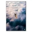 Girl in bikini, diving in fluffy white and blue clouds in surreal wall art.