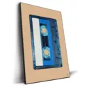 Translucent blue audio cassette tape with a white and blue label against a warm tan background.