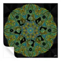 Intricate pattern with gold and turquoise lines radiating from a detailed center against a black background.