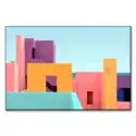 Dreamlike colored architecture with a sea view, featuring orange, pink, and purple structures.