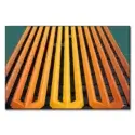Building facade with vertical orange and yellow stripes against a green backdrop.