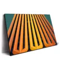 Modern building facade with vertical orange and yellow stripes.
