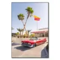 Vintage convertible parked in front of an In-N-Out Burger with palm trees and a clear blue sky.
