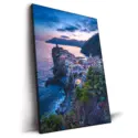 Vernazza village in Italy at sunset with colorful buildings by the sea.