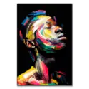 Bold abstract portrait of a face with dynamic brushstrokes in red, yellow, and blue, creating a powerful, energetic expression on a dark background.
