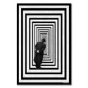 A man standing in an optical illusion hallway with black and white concentric stripes, creating a sense of infinite space.